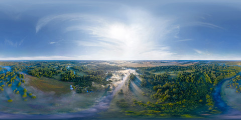 Fototapeta na wymiar 360-degree panoramic aerial view of the field, forest and river covered with a thick layer of morning fog