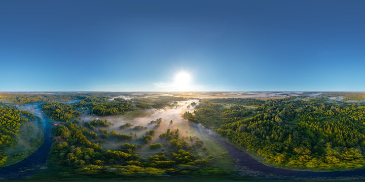 360-degree panoramic aerial view of the field, forest and river covered with a thick layer of morning fog