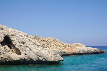 view of a small rock protruding into the sea on a Sunny day. Rest at sea, tourism, holidays. Beautiful view of the coast