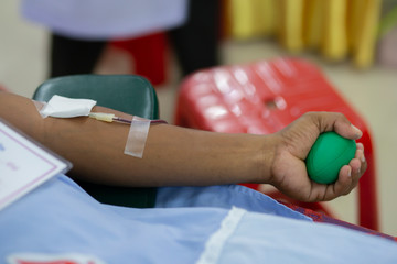 Blood donor at donation with a bouncy ball holding in hand. image for Thai Aug 2019.
