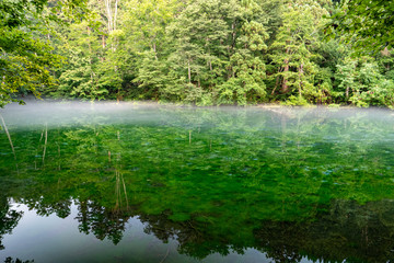 Mysterious lake covered with fog