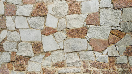 Texture of a stone wall of a castle piled from stones background