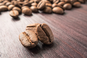 Close-up of coffee beans on dark wooden background