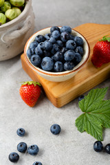 Fresh blueberry in small bowl close-up