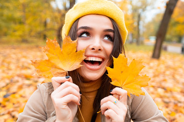 Autumn woman in autumn park. Warm sunny weather. Fall concept.A beautiful female dreaming in the autumn park.