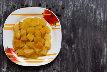 Top view of cut cooked squash on black background