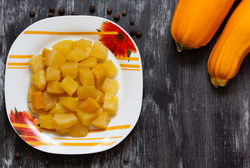 Top view of cut cooked squash on black background