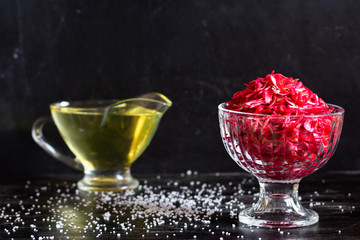 Raw beetroot, carrot and cabbage salad on black background