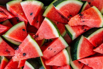 Red watermelon,heap of watermelon slices as background
