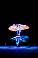 Arabic dancer twirling at night in dessert outside UAE with slow shutter and movement