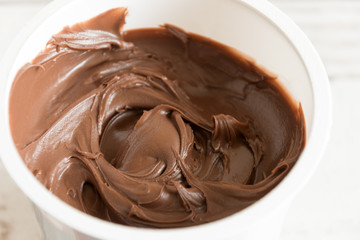 Chocolate cream dessert swirling in a white plate.