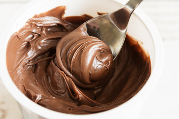 Chocolate cream dessert swirling in a white plate.