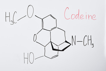 top view of white board with chemical formula and lettering codeine