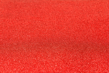 Shiny glitter red bachground texture. Glittering red paper