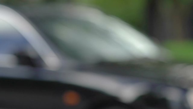 Woman taking car key with red ribbon from dealer hand, transport purchase, rent