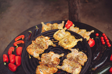 The chef is cooking meat on the grill. Golden rib steaks and chicken with grilled vegetables, delicious food