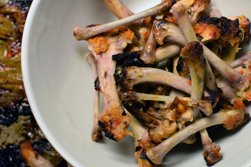 Leftovers after eating grilled wings. Chicken bones, close up top view. 