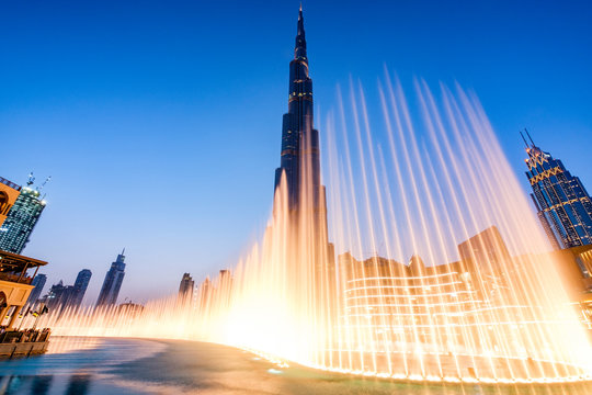 Fountains in Dubai mall overlooking Dubai cityscape and buildings