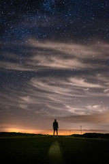 Fototapeta na wymiar Silhouette of a man at night, under the stars in Sagres, Portugal