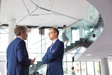 Businessmen discussing while standing at new office