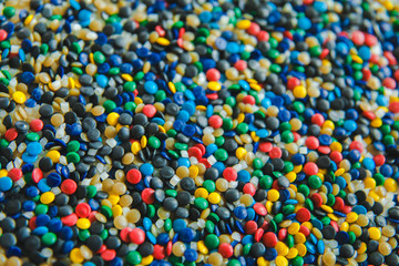 Fototapeta na wymiar Industrial colorful Polymeric dye. Plastic pellets. Colorant for plastics. Pigment in the plastic polyethylene granules background texture.