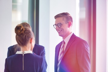 Business people talking to colleagues in office