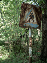 Old rusty pedestrian crossing road sign in Chernobyl-2 in Chernobyl Exclusion Zone, Ukraine