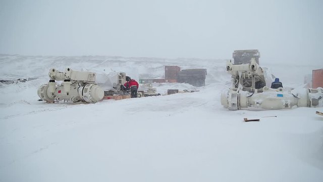 repair base near open pit coal. Severe weather conditions, blizzard with snow and strong wind