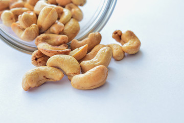 Dry cashew nuts in glass bottle isolated with background. Snack for eat 