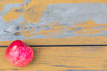 Fresh red apples lie on a wooden surface.Horizontally.