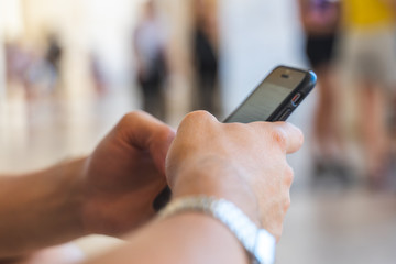 close up male hands checking mobile smart phone and touching smartphone screen concept.
