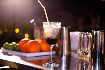 Set of cocktails on the bar counter. Night club, evening party. Lights bokeh on 