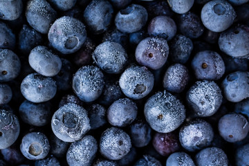 Frozen blueberries as background.  Healthy organic fruit. Natural antioxidant. Close up.