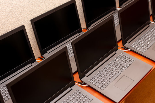 many laptops are on the table. computer exhibition demonstration. it technology