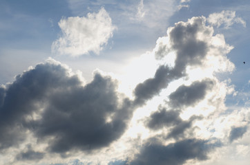 Fototapeta na wymiar Sun at cloudy sky, cumulus clouds lights in sun rays