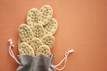 Reusable canvas bag and multigrain biscuits. Care for the environment and health.