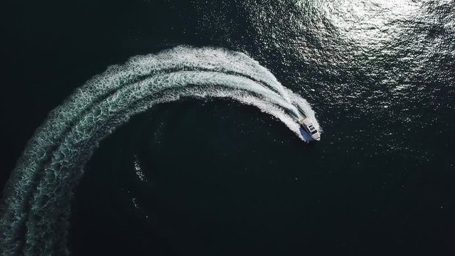 Aerial view of a luxury yacht navigating fast.