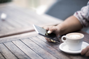 Close up of women's hands holding mobile phone with blank copy space screen for your advertising text message or promotional content.