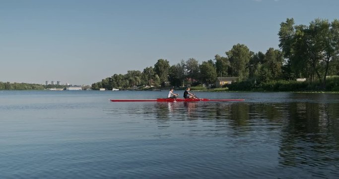 Young sports team two teenage boys with a double boat kayak on the water