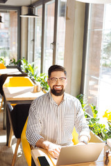 Nice handsome man working remotely on the laptop