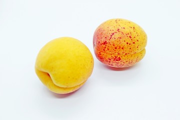 DelicDelicious juicy apricots are located on a white backgroundious juicy apricots are located on a white background
