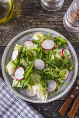 Radish salad with arugula and lettuce. Diet and healthy food. Top view.