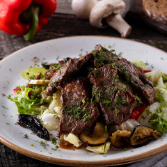 Warm salad with roasted veal and vegetables. Closeup