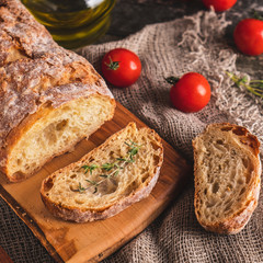 Freshly baked ciabatta bread on wooden cutting board. Tasty Ciabatta bread. Closeup