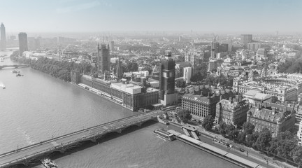 Aerial view of London with Westminster Bridge, Palace of Westminster and Big Ben being renovated in the distance. Black and White