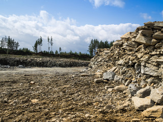 Stone extraction from quarry artificial. Excavator working in the pit