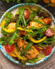 Chicken salad on a plate. Roasted chicken with fresh vegetables and lettuce.