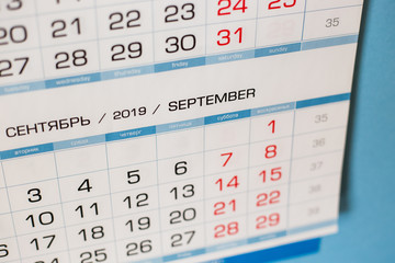 Close-up calendar for the month of September 2019. Hello September. Hello, Autumn. Russian-English calendar on a blue background