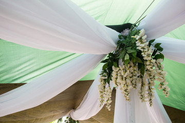 Getting ready for the wedding ceremony. Decor of white wisteria closeup