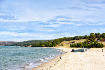 Fototapeta na wymiar Coast of Lake Baikal on the island of Olkhon. Landscape with boat and seagulls